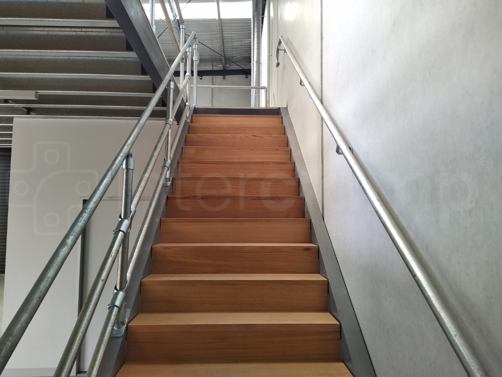 Interclamp 5000 series used on access stairs to a mezzanine floor